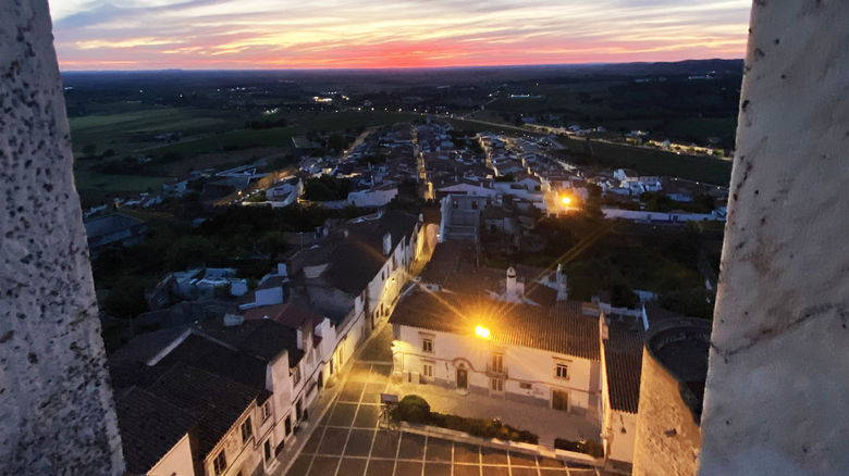 The white marble buildings of Estremoz from the Estremoz Castle as the sun sets.