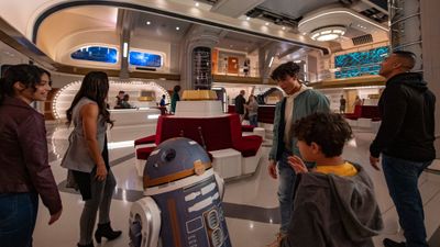 A droid greets guests at Star Wars: Galactic Starcruiser.
